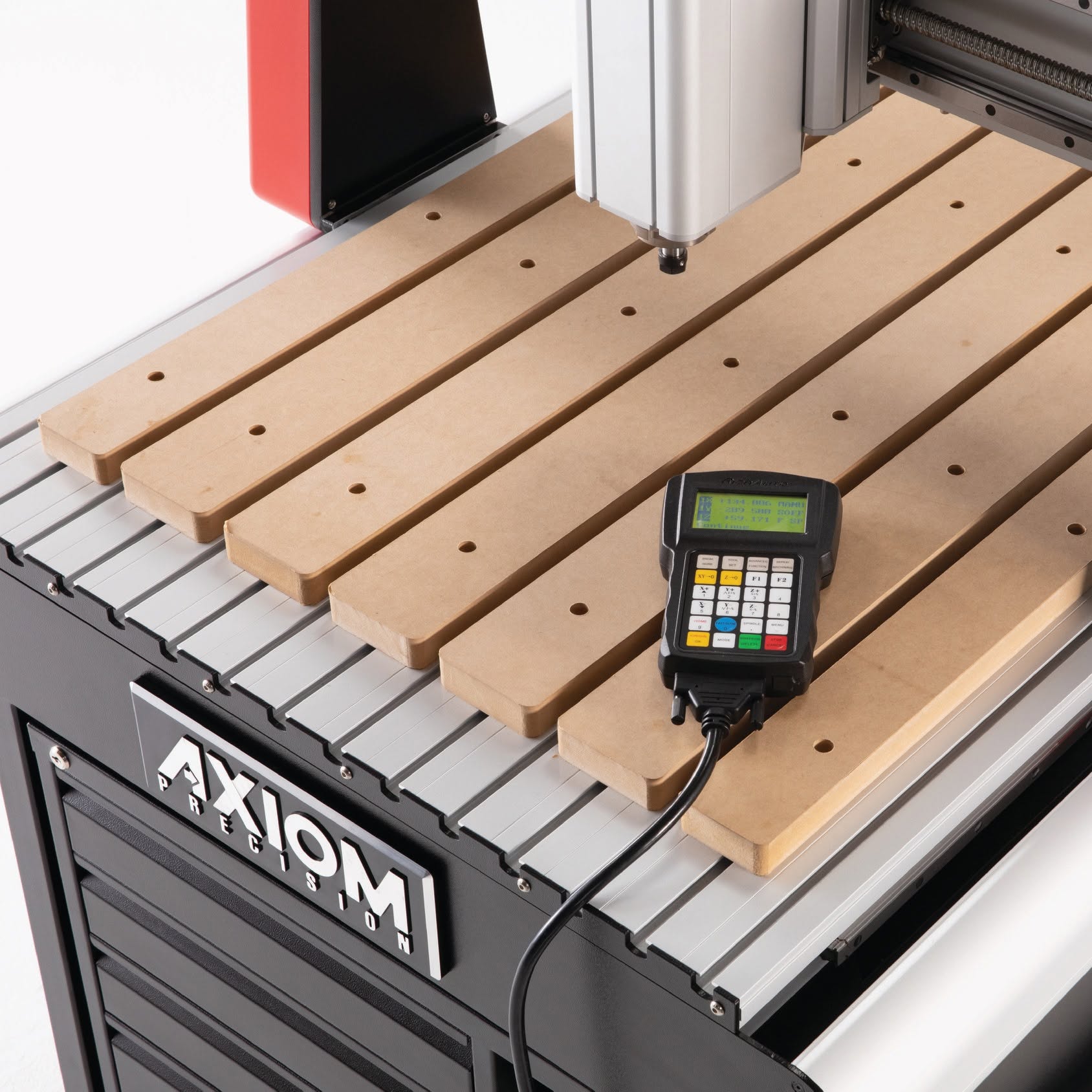 Close-up of an Axiom CNC router spindle, work surface and handheld controller