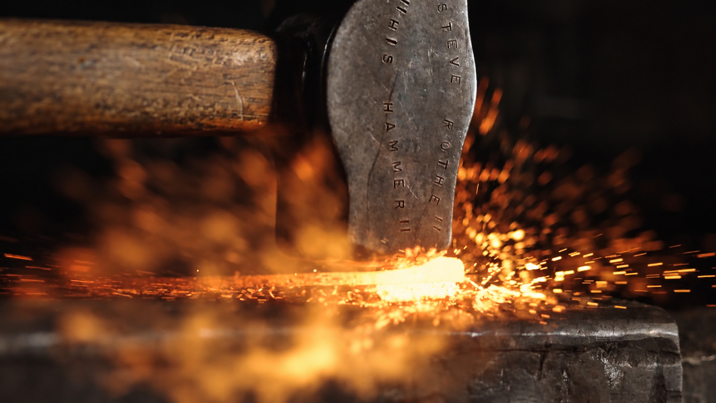 Hammer striking hot metal
