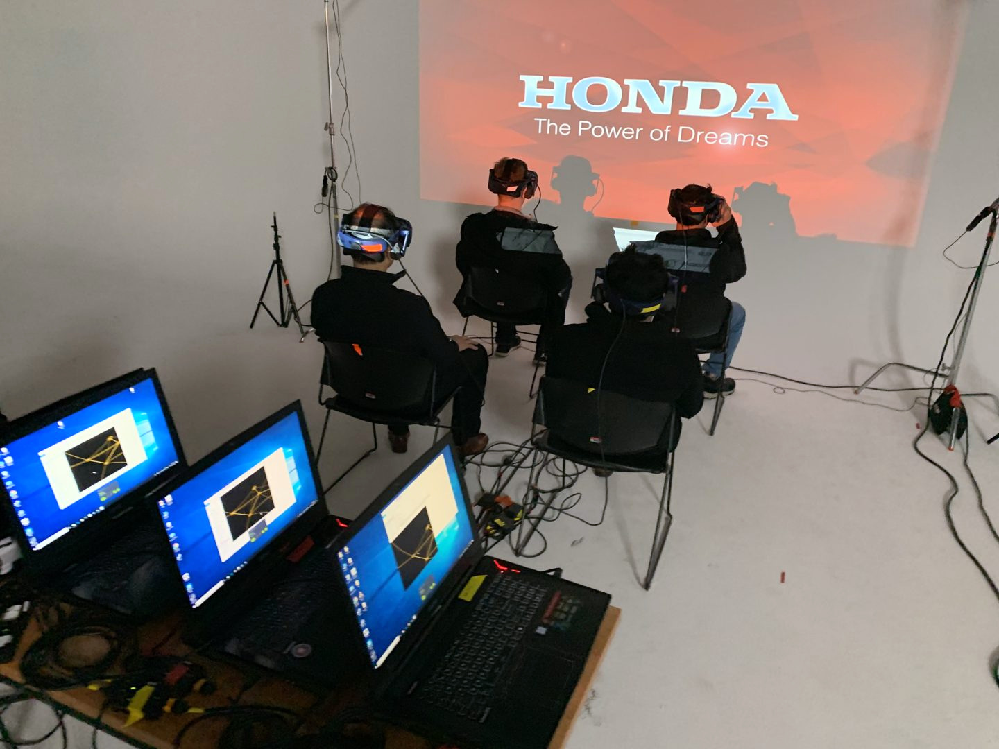 Crew testing VR headsets with laptops in the studio