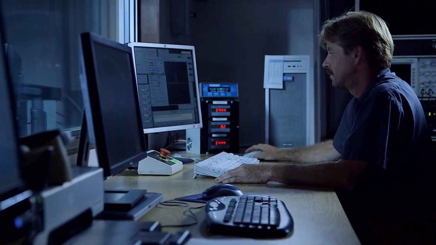 Technician working at computer monitors