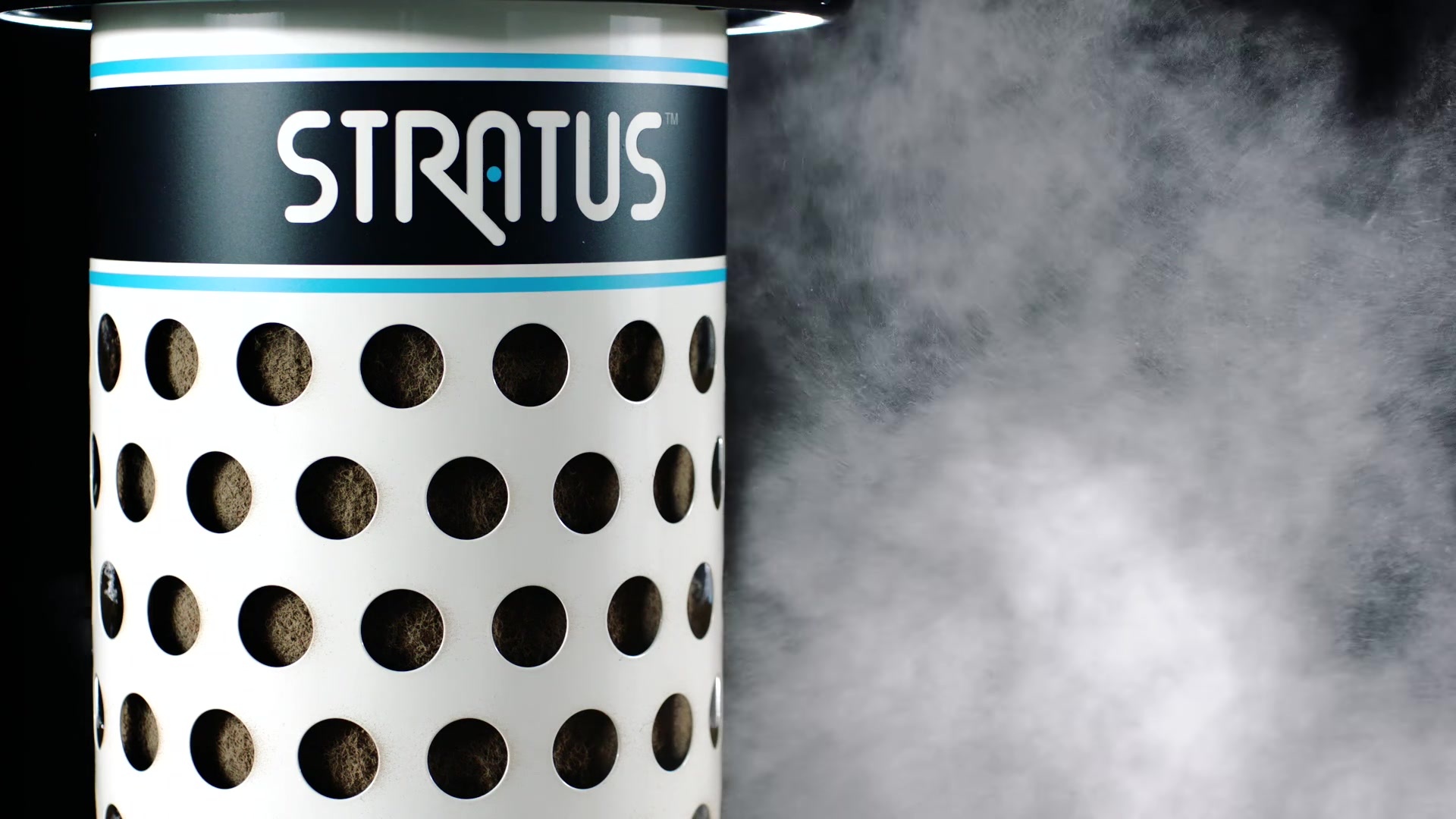 A visible cloud of dust moving toward the STRATUS air cleaner against a black background